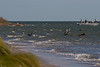 SundownIsland > I suspect these juvenile pelicans are hanging out close to the fisherman for a free snack. This is at the Northeast end of the island.  Notice how choppy the water is.  There was also a high tide so there wasn't much beach to walk on here. Photo credit: Marcy Crowe Spears 