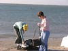 SundownIsland > Nicole Janak (left) and Monique Wells try to find a dry spot for their gear before heading to one of the work locations. (Photo credit: Steve Tripp)