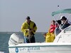 SundownIsland > Gary Eskelson gets ready to toss the anchor after picking up the last group of Devon volunteers. (Photo credit: Hannah Olson)