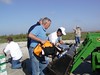 SundownIsland > Ed Olson, Gary Eskelson, and Richard Brietzke load up the tractor to move supplies and equipment to the work sites. (Photo credit: Hannah Olson)