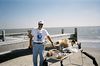 SundownIsland > Richard points at the most interesting item found during the beach cleanup. (Photo credit: Lynn Travis)