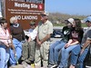 SundownIsland > As Abe Moore films, Chester Smith talks about Sundown Island, its birth, growth and all other problems in between, while volunteers listen. L to R: Monique Wells, Linda Olson, Andy, Chester Smith, Hannah Olson, Rebekah Olson and Linda Barley. (Photo credit: Steve Tripp)