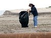 SundownIsland > Cheryl Marwitz is picking up trash close to the dredge fill site on the Northwest end of the island.