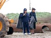 SundownIsland > Linda Barley and Connnie Knepp (sisters) are picking up trash and trying to figure out how best to move through the mud ahead.