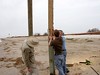 SundownIsland > Mark Elwonger and Andrew and Ed Olson are piecing together two pieces of wood to mount one of the new "posted signs" provided by U.S. Fish and Wildlife Services.