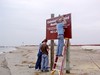 SundownIsland > Hannah Olson hauled the ladder over the sign installation so that Andrew and Ed could mount the new sign on the posts.