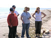 SundownIsland > Brenda, Hanna, and Molly Eskelson and Jim Schuelke ponder how they will vote in the "Most Unusual Trash Found" contest.  (photo by Steve Tripp)