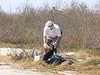 SundownIsland > Devon volunteer Bill Parker continues his trash pickup duties after the lunch break.   (photo by Steve Tripp)