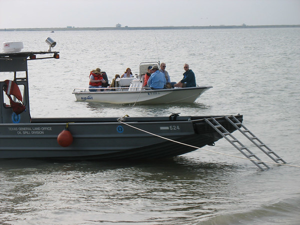 SundownIsland > Capt. Bob Hill brings the first load of Devon volunteers to the island and parks next to the General Land Office boat. (photo by Peggy Wilkinson)