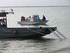 SundownIsland > Capt. Bob Hill brings the first load of Devon volunteers to the island and parks next to the General Land Office boat. (photo by Peggy Wilkinson)