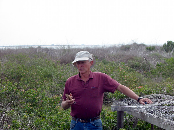 SundownIsland > Ed Olson stops to explain what he is doing for Abe Moore, who is filming the crew while they take the nesting stands apart. Ed and his sons and daughters built many of the nesting stands on the island, when they were needed to protect the Pelicans and their chicks. (Photo credit: Hannah Olson)