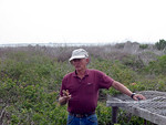 SundownIsland > Ed Olson stops to explain what he is doing for Abe Moore, who is filming the crew while they take the nesting stands apart. Ed and his sons and daughters built many of the nesting stands on the island, when they were needed to protect the Pelicans and their chicks. (Photo credit: Hannah Olson)