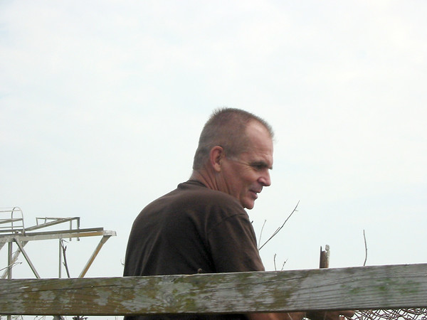 SundownIsland > Doug Wilkinson rolls up the fencing on this nesting stand. (Photo credit: Hannah Olson)