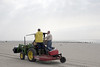 SundownIsland > Tim Wilkinson (driving tractor), Ed Taylor and Richard Prater haul supplies from the boat to the shed. (Photo credit: Marcy Spears)