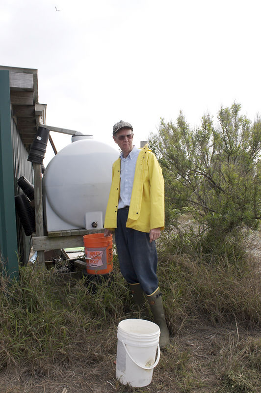 SundownIsland > Ed Taylor loads up the buckets with water and fertilizer for the new trees that are to be planted today.  (Photo credit: Marcy Spears)