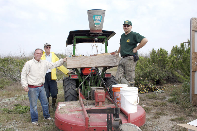 SundownIsland > (L to R) Richard Prater, Ed Taylor, and Niell Irvin (Government Land Office) posed just before leaving for the tree plot with the water and fertilizer.  (Photo credit: Marcy Spears)