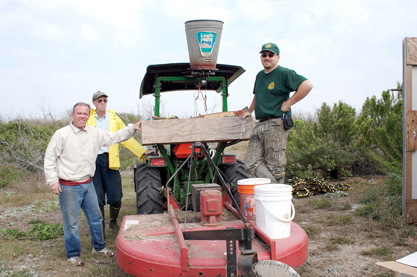 SundownIsland > (L to R) Richard Prater, Ed Taylor, and Niell Irvin (Government Land Office) posed just before leaving for the tree plot with the water and fertilizer.  (Photo credit: Marcy Spears)
