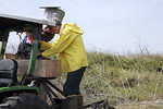 SundownIsland > Ed Taylor and Tim Wilkinson disconnect the spreader used for the fire ant killer just before putting the tractor away for the day. (Photo credit: Marcy Spears)