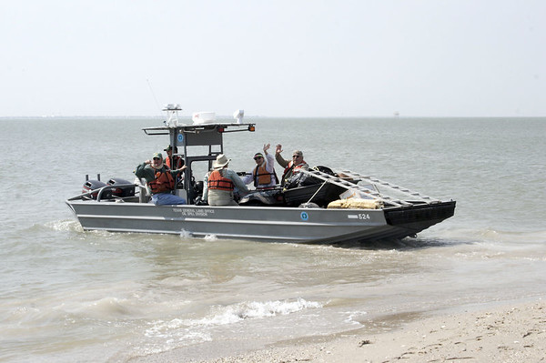 SundownIsland > The Government Land Office boat pulls out first to head back to Port O'Connor with Rob Muir, Niell Irvin, Mark Elwonger and Nelda and Abel DeLeon. They are also taking the trash collected along the beach to be disposed of properly.  (Photo credit: Marcy Spears)