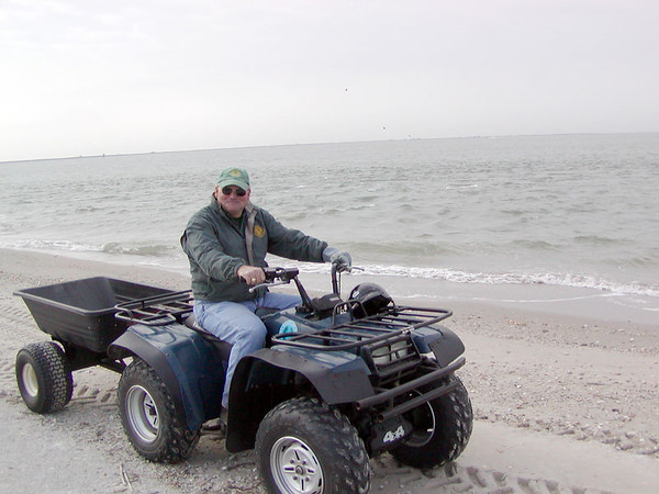 SundownIsland > Rob Muir (Government Land Office) unloads the four-wheeler and prepares to move supplies to the shed and then to pick up bagged trash from the beach clean-up. (Photo credit: Rebeka Olson)