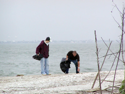 SundownIsland > Tyler and his Uncle Doug Wilkinson pick up trash along the East side of the beach. (Photo credit: Rebeka Olson)