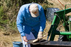 SundownIsland > Gary is still at it.  He is cleaning off the air filter.  There was so much over growth it was hard to keep the tractor happy. I also overheard something about needing a battery (not sure what equipment it was for).   Photo credit: Marcy Crowe Spears