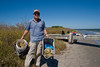 SundownIsland > Tim Wilkinson shows off his collection of beach trash.  He found the buckets and the line.  Photo credit: Marcy Crowe Spears