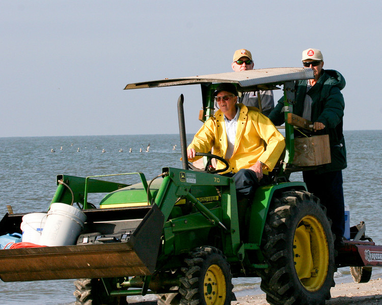 SundownIsland > Ed Taylor (driving the tractor) picked up supplies brought in on the Egret II along with Ronnie Zetik and Robert Fairchild for the ride back to the shed.Photo credit: Marcy Spears