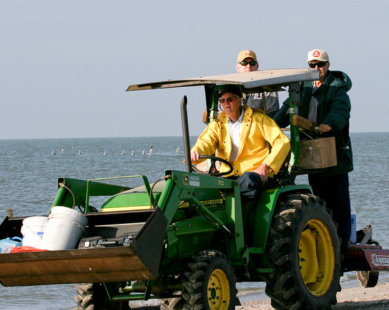 SundownIsland > Ed Taylor (driving the tractor) picked up supplies brought in on the Egret II along with Ronnie Zetik and Robert Fairchild for the ride back to the shed.Photo credit: Marcy Spears