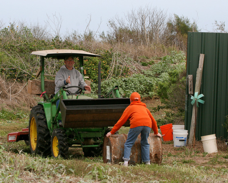 SundownIsland > Jeremy King helps his Dad (Jackie King) by placing barrels to be smashed in front of the tractor. Photo credit: Marcy Spears