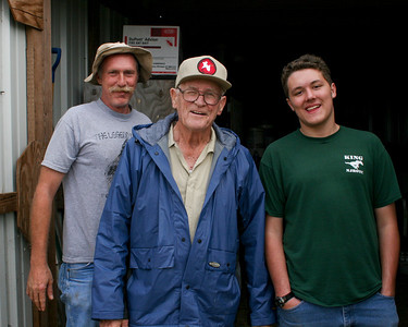 Here are our two water hitch-hikers, shortly after than arrived: (Greg (left) and Eric (right) Giggleman with Chester Smith (center) at the tractor shed.
Photo credit: Marcy Spears