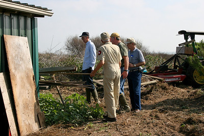 Ed, Chester, Ronnie and Robert start moving old lumber to the burn pile.Photo credit: Marcy Spears