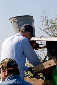 Tim Wilkinson (front) and Ed Taylor (on tractor) attach the spreader to treat for fire ants.
Photo credit: Marcy Spears