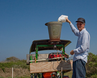 Ed Taylor fills the spread with chemicals to treat for fire ants.
Photo credit: Marcy Spears