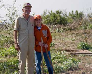 Young recruit, Jeremy King (right) stands with Warden Chester Smith.  Notice the great sticks that Jeremy found!  They will be great for walking around the island and poking ahead to scare off snakes.
Photo credit: Marcy Spears