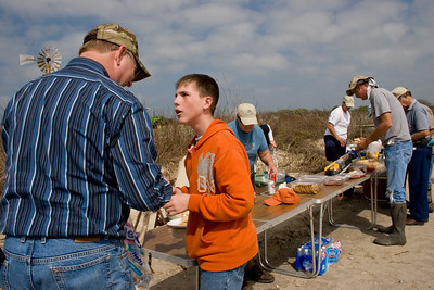Jeremey King picked up trash along the beach and shells.  He shows his Dad (Jacie) some of the shells during the lunch break.
Photo credit: Marcy Spears