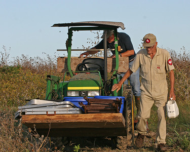 Rony Zetik and Chester Smith went to the tractor shed to pick get the tractor and bring supplies.  For once I did not hear a gun shot.  There is almost always a rattler who has taken up residence in the shed.

Here, Rony and Chester return to the dock area with the tables, supplies and chairs. These are set up on the beach for the volunteers.