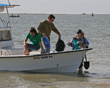 Tim hands Brenda her backpack while Priscla jumps ship.  Notice that Brenda brought her own shovel!
